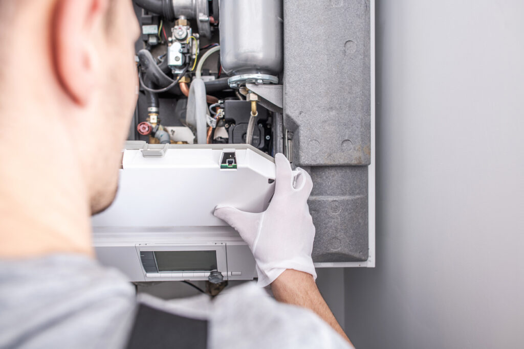Close up of an HVAC technician working on a furnace