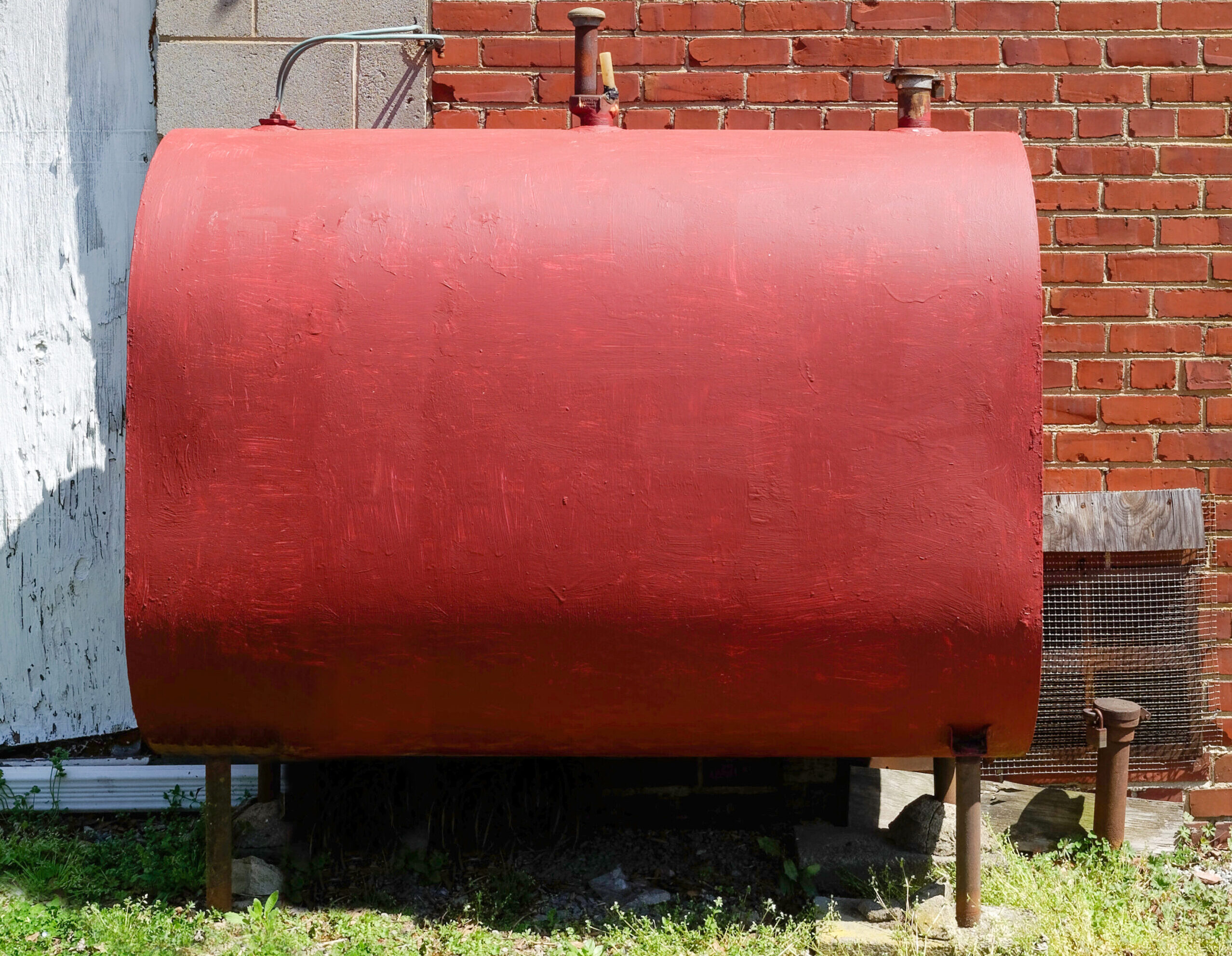 Freshly red painted home heating oil tank