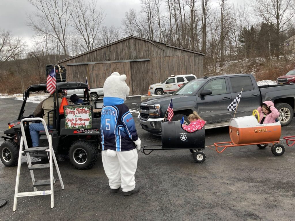 Arctic Bear mascot entertaining children on a small train